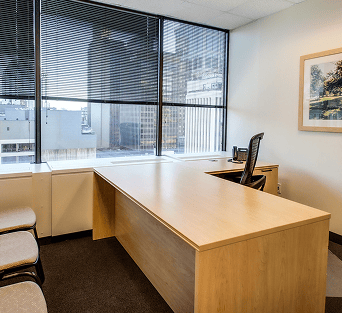 Office interior featuring a spacious desk and large window views in France.
