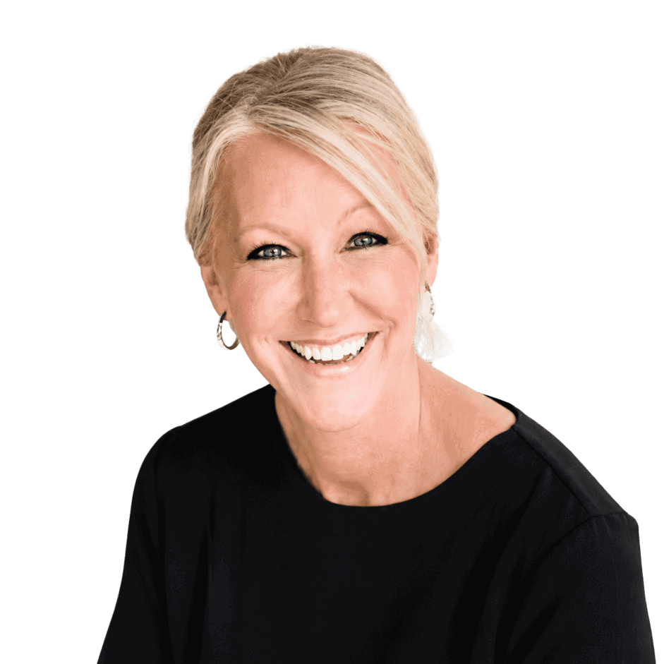Smiling woman with short blonde hair wearing a black top, representing professional success and confidence.