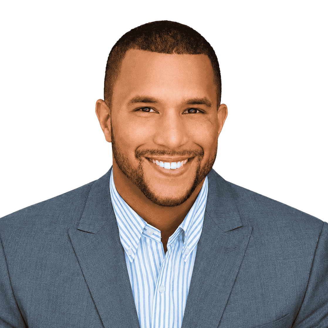 Professional man in a suit smiling, representing business success and franchising opportunities.