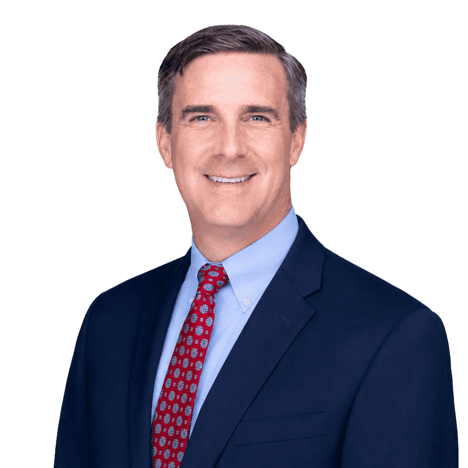 Professional businessman in a navy suit and red tie smiling, representing franchising opportunities with Intelligent Office.