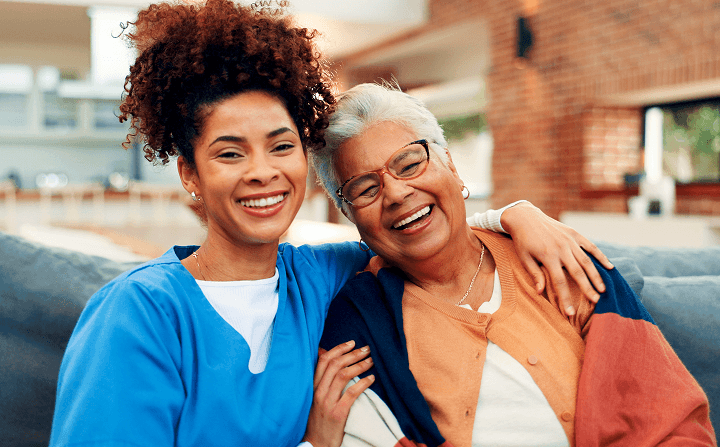 Two women smiling and embracing, representing successful franchising and business growth in the intelligent office industry.