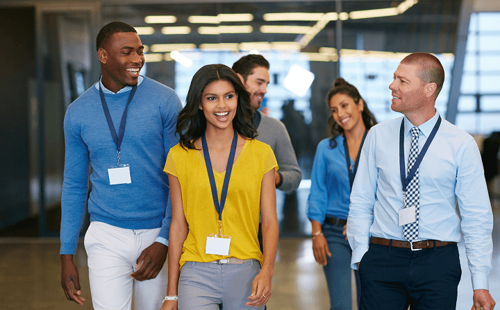 Diverse business professionals engaging and networking at a corporate conference, representing collaboration and professional growth.